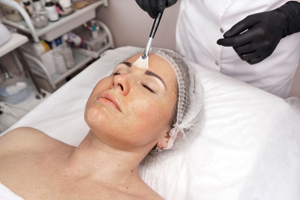 A woman is getting a facial treatment in a beauty salon.