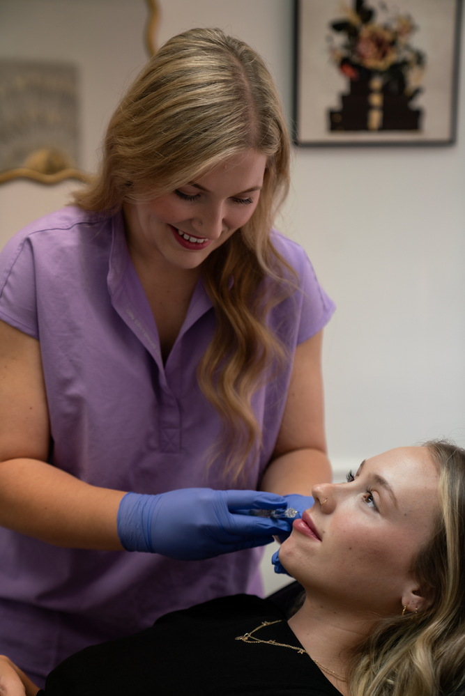 A woman is getting a botox injection in her face.