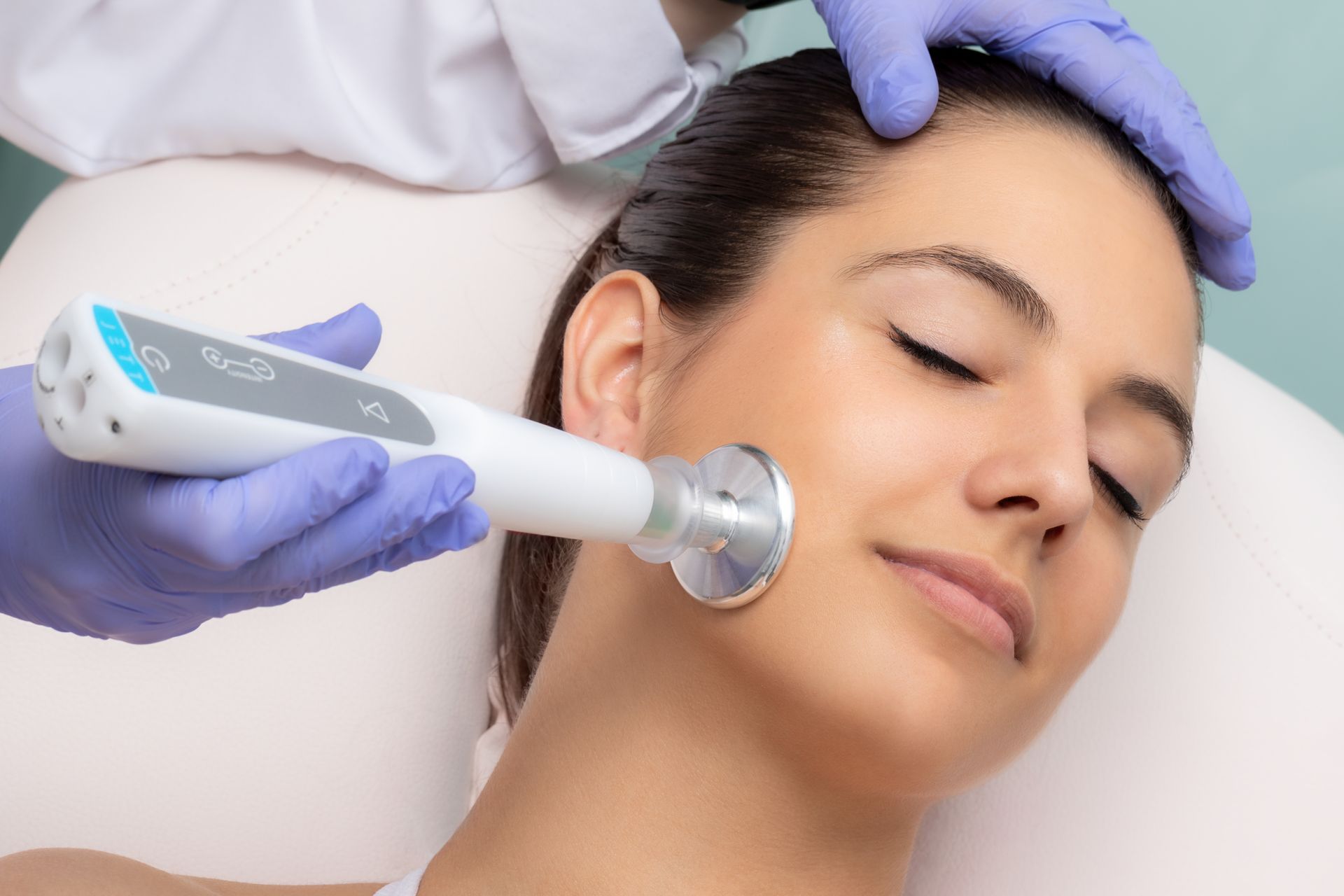 A woman is getting a plasma pen treatment on her face.