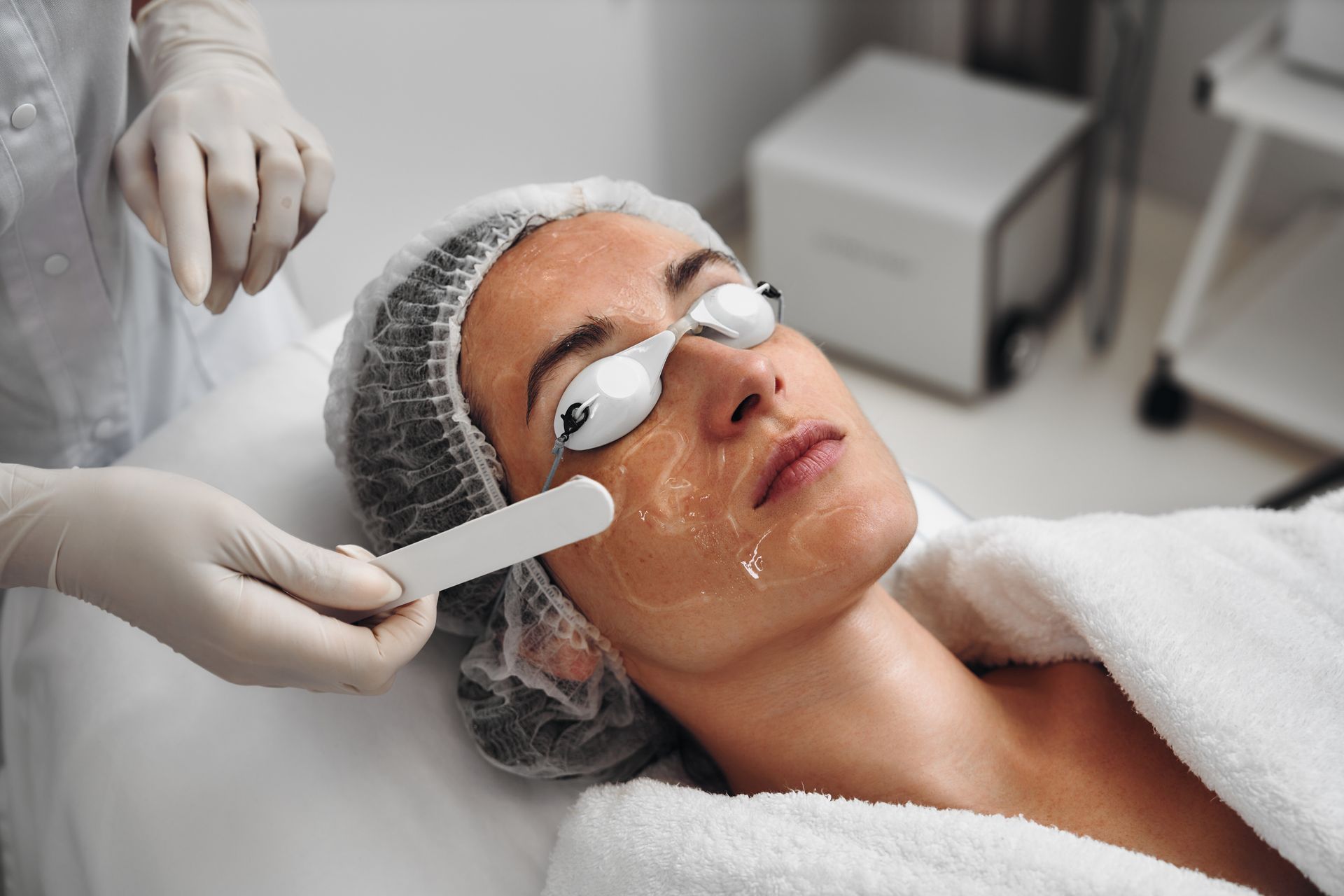 A man is getting a facial treatment at a beauty salon.