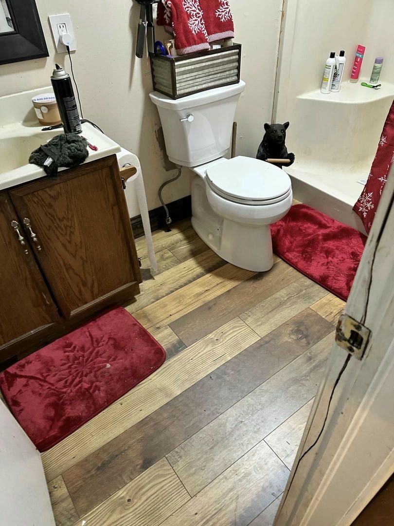 A bathroom with a toilet , sink , and bathtub.