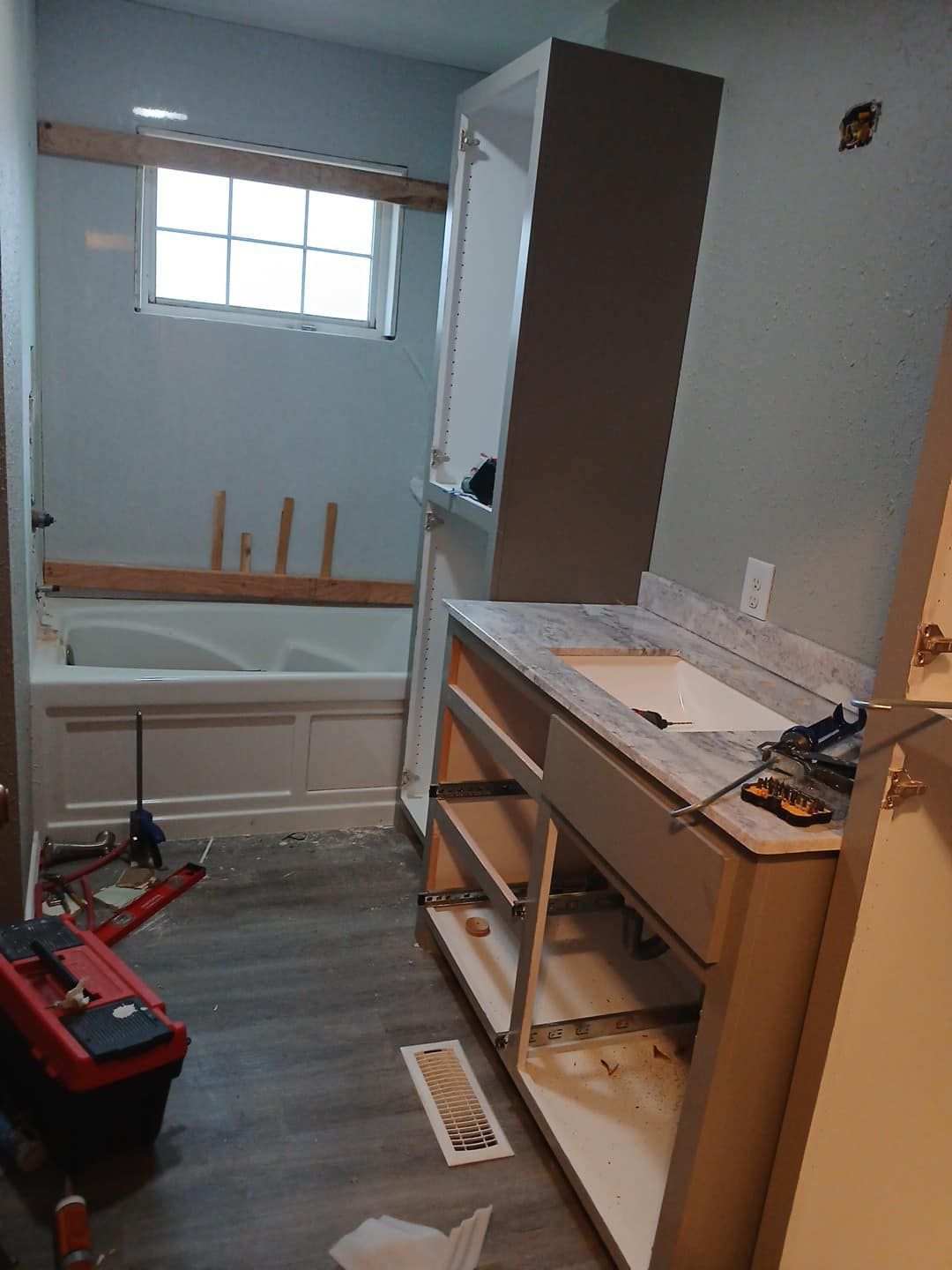 A bathroom with a sink and a bathtub being built.