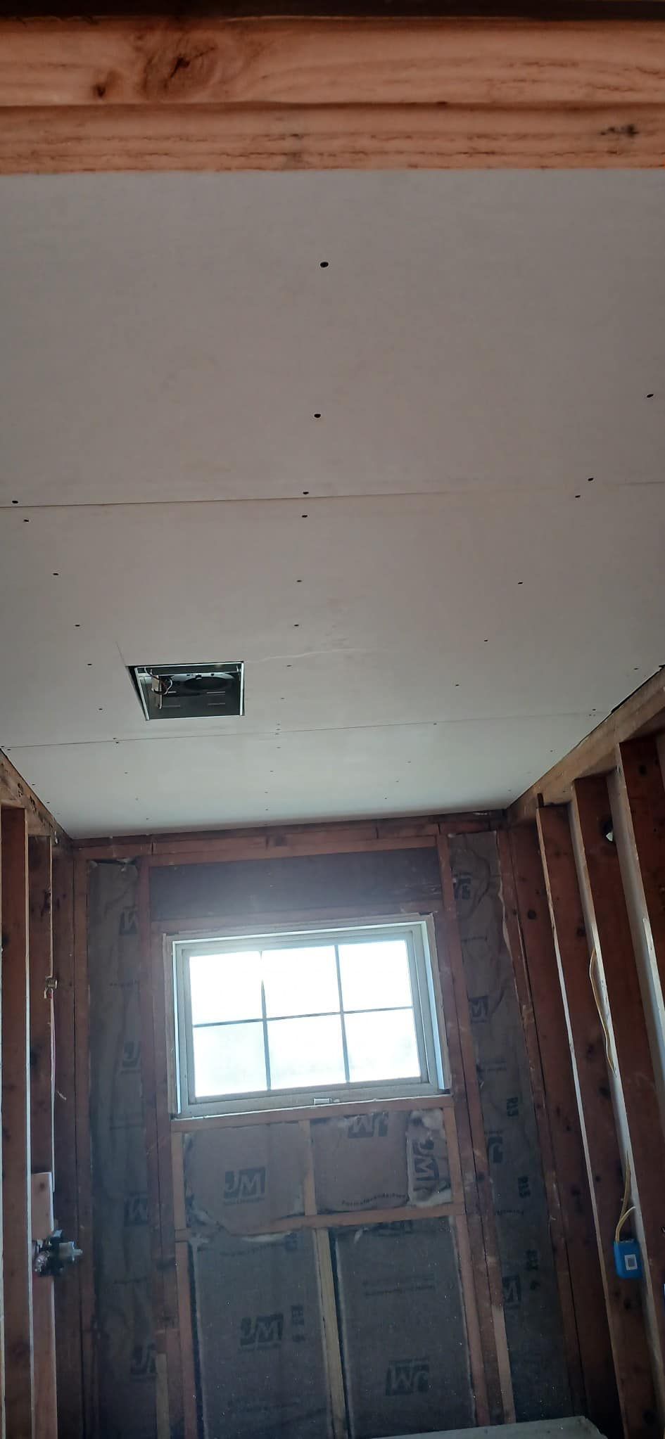 There is a window in the ceiling of the room.