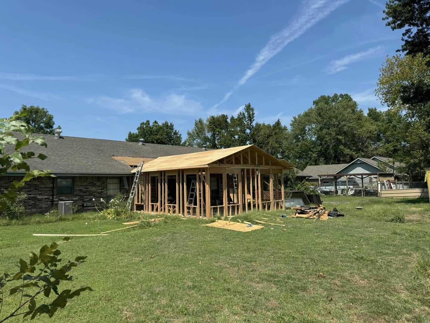 A house is being built in the backyard of a house.