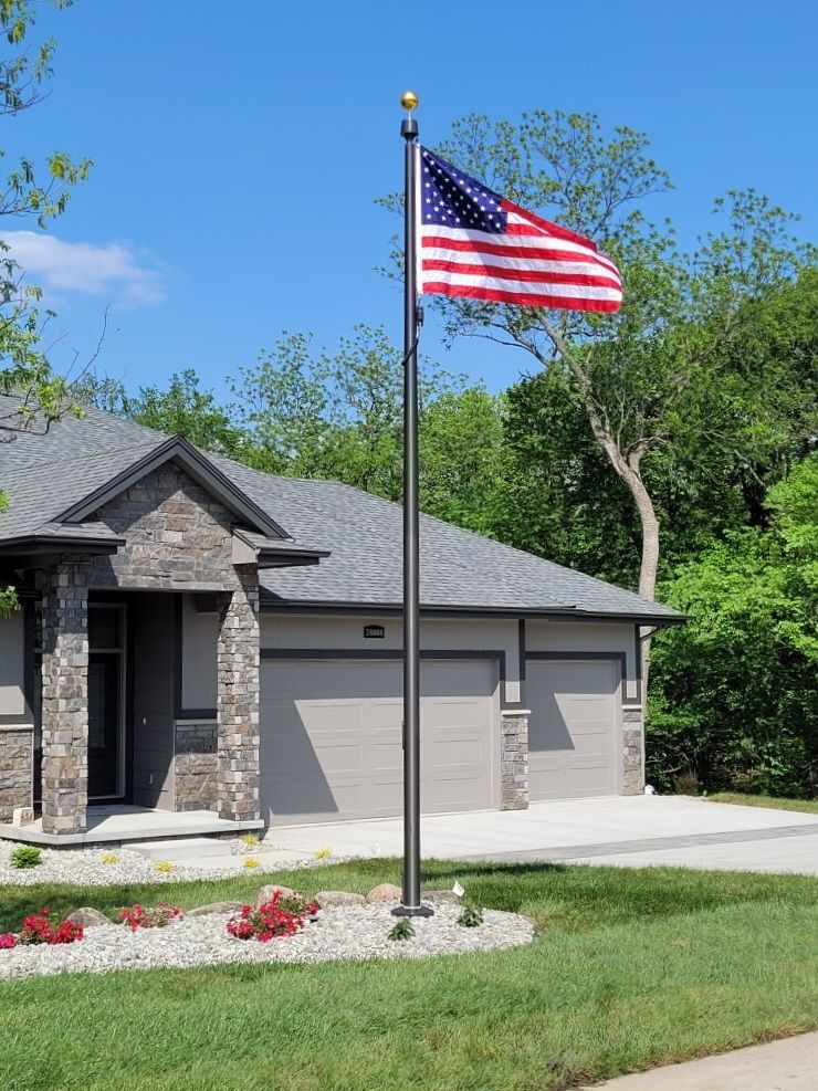 An american flag is flying in front of a house