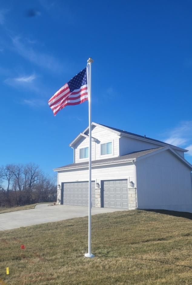 An american flag is flying in front of a white house
