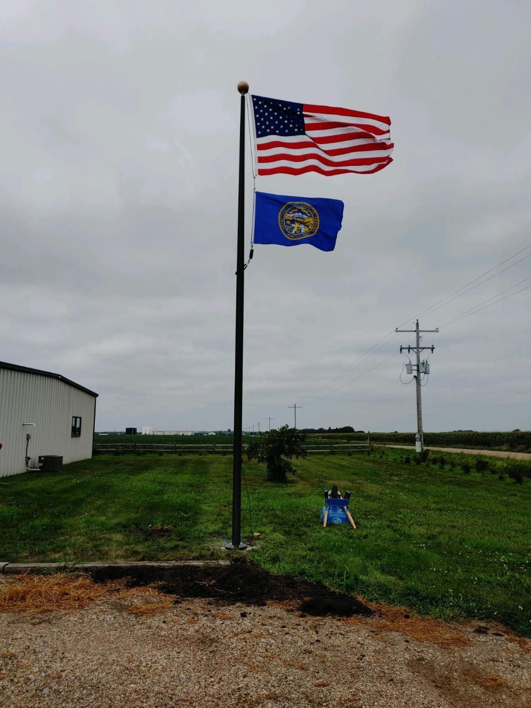 25 Bronze Sentry Flag Pole With Bricked House — Omaha, NE — A -1 Flags, Poles, and Repair