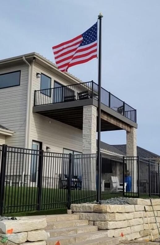 25 Black Flag Pole With Elegant House — Omaha, NE — A -1 Flags, Poles, and Repair