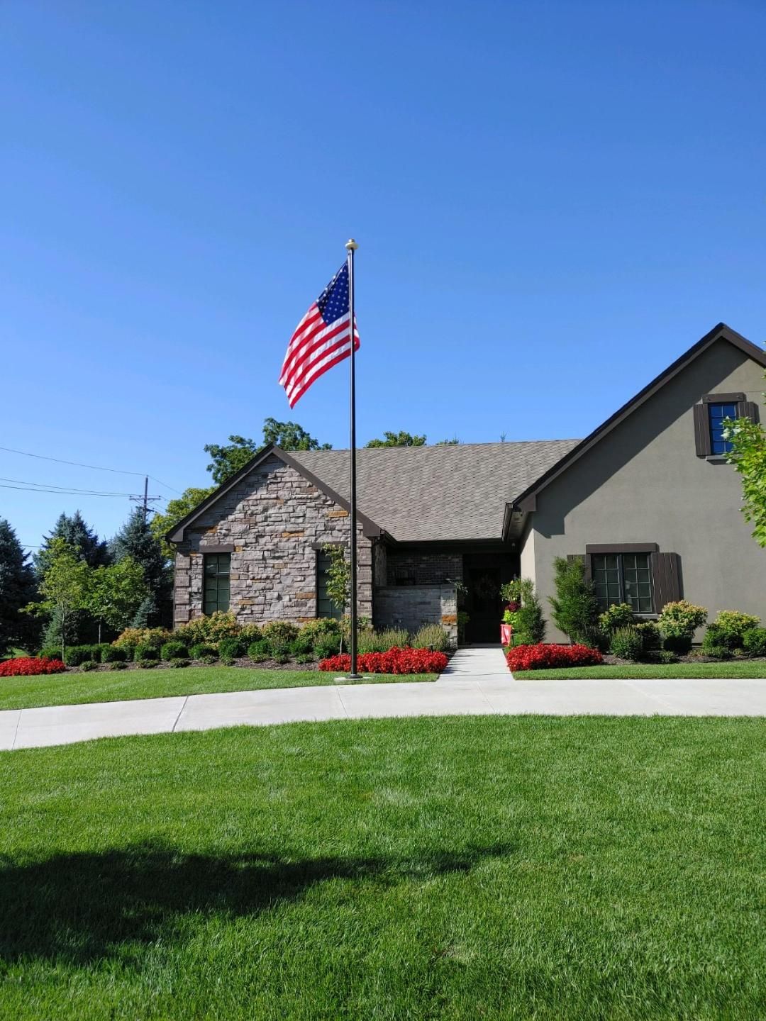 An american flag is flying in front of a house
