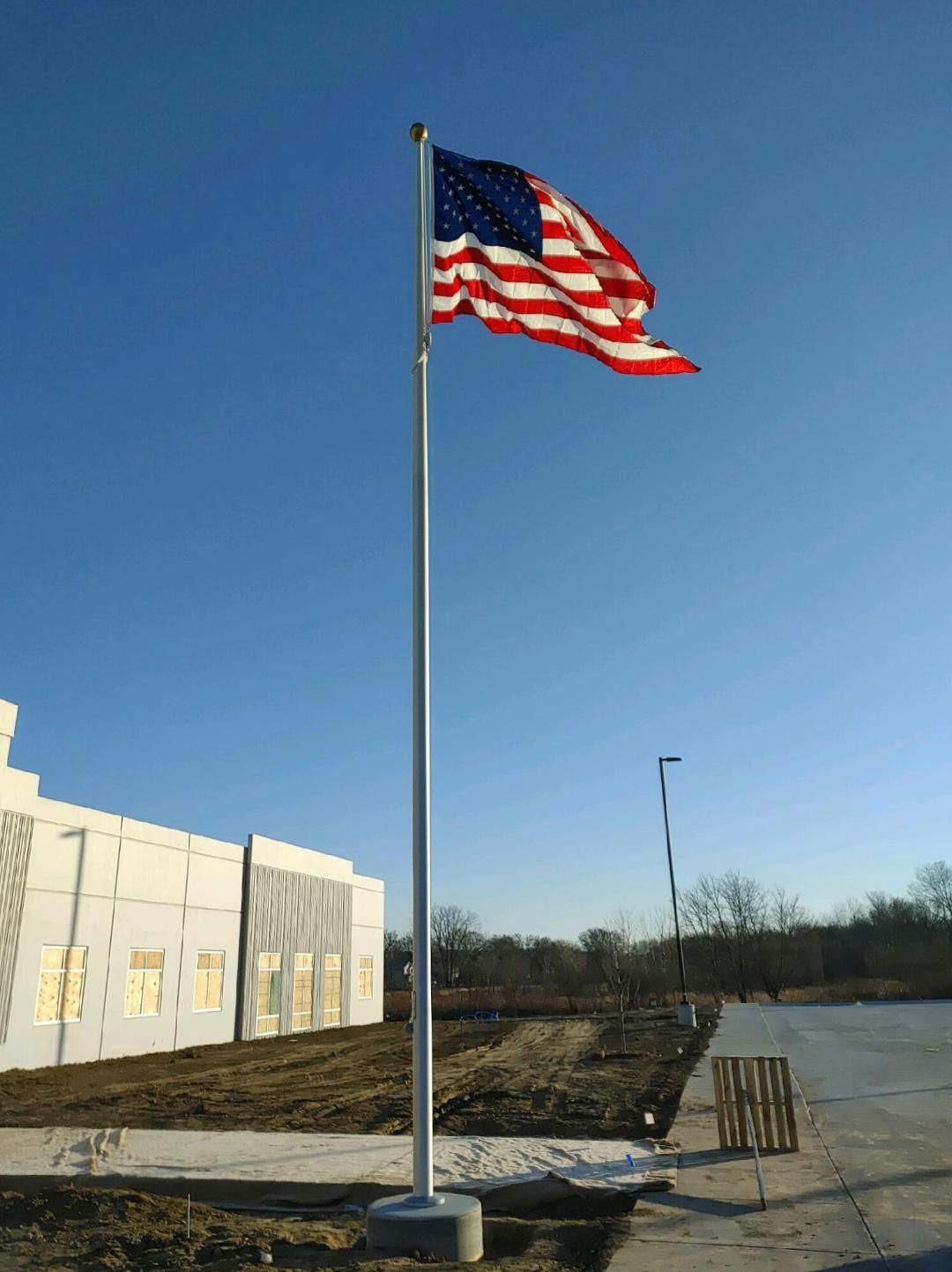 An american flag is flying in front of a building