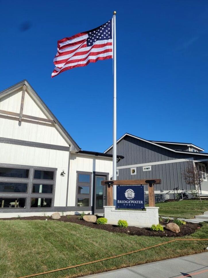 An american flag is flying in front of a house