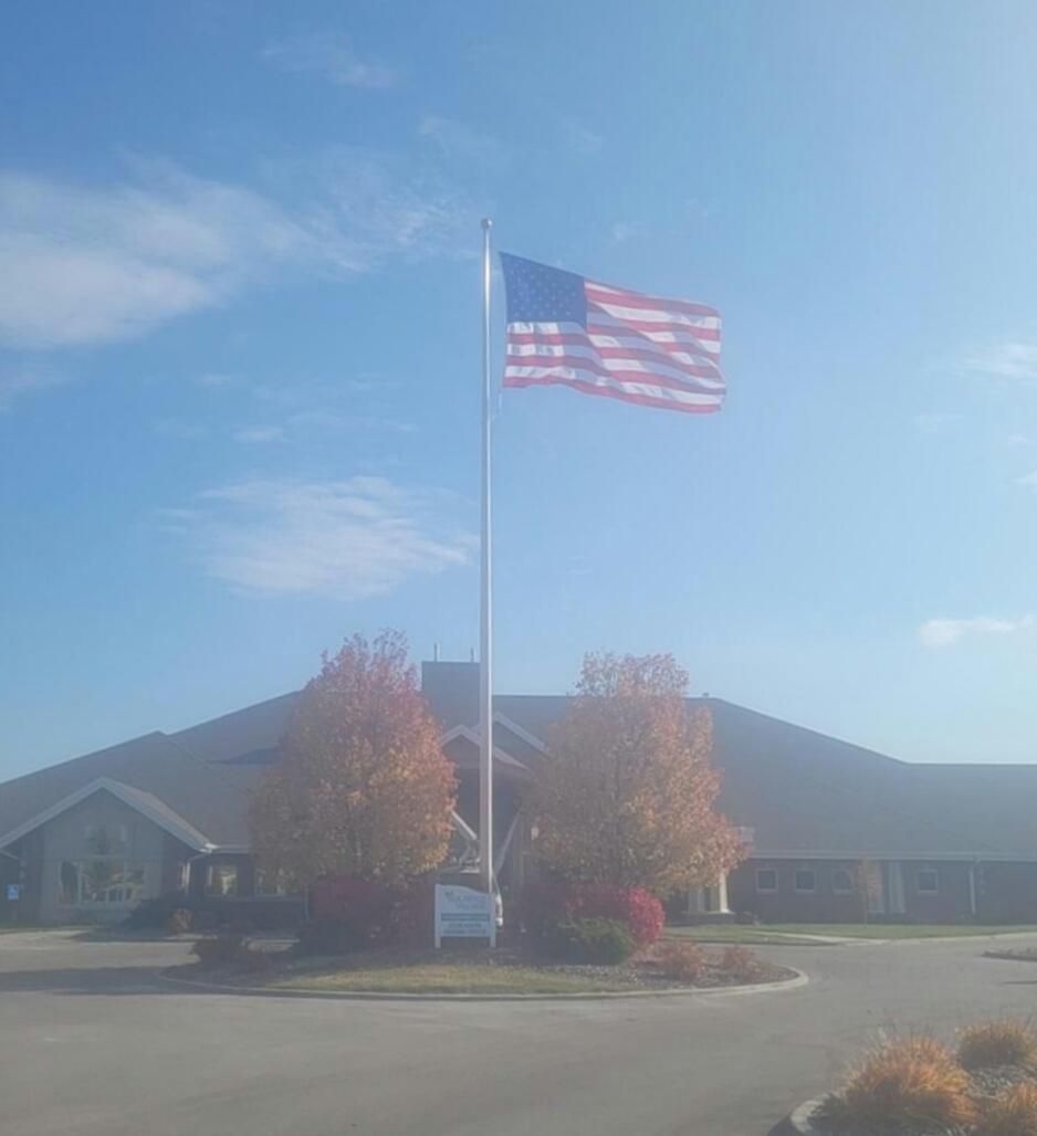An american flag is flying in front of a building