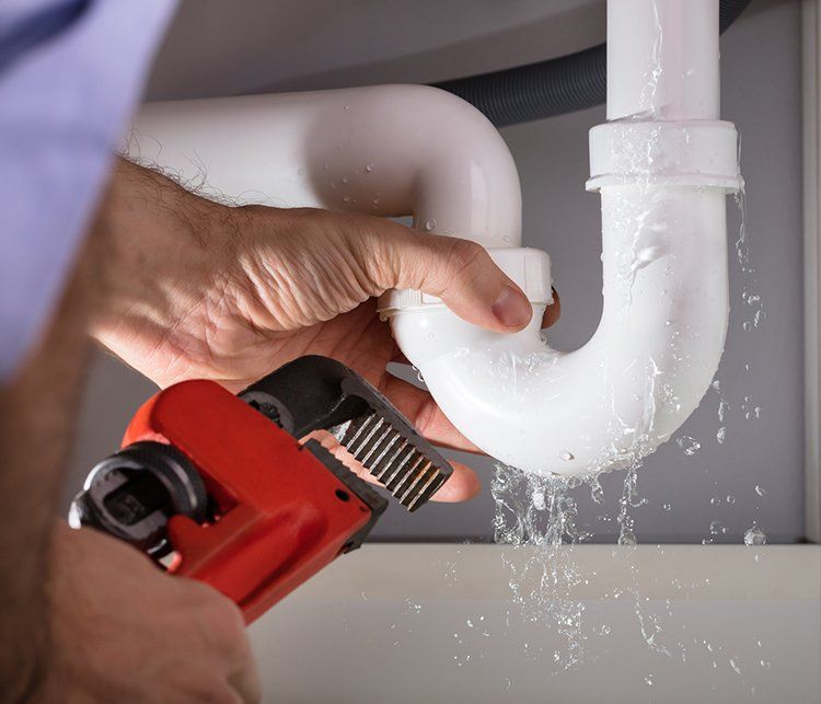 Fixing the Sink Pipe with Wrench — Elkhart, IN — Eby Plumbing Plus Inc