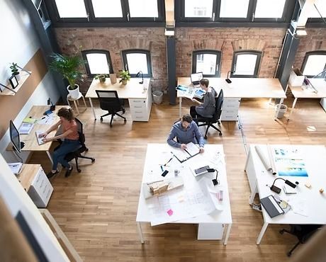 An overhead view of a modern office space with employees working at desks.