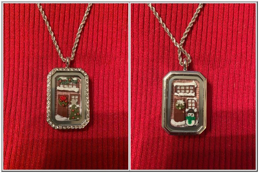 Two small rectangular pendants with festive scenes, shown side by side on red fabric.