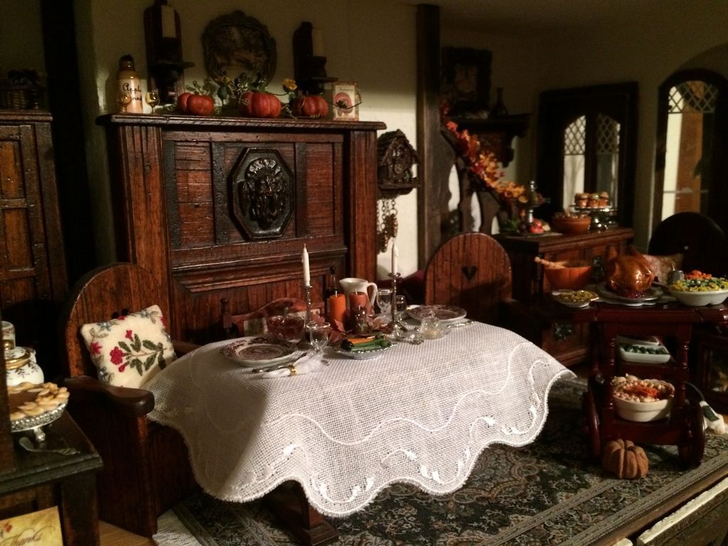 Victorian-style dining room with carved wood furniture, lace tablecloth, and floral accents