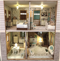 Miniature dollhouse interior with three furnished rooms, floral wallpaper, and warm lighting
