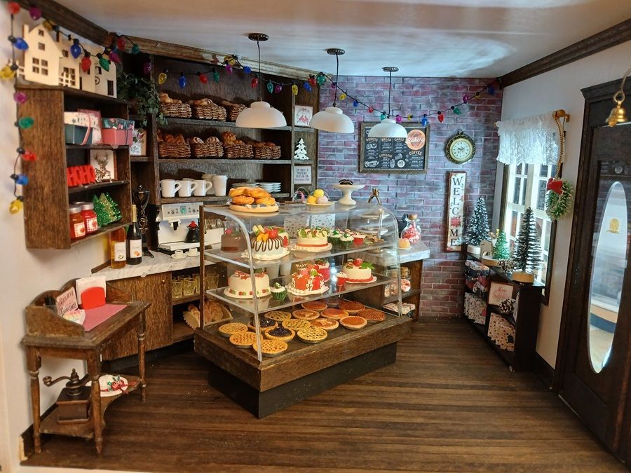 Cozy bakery shop interior with glass pastry cases, shelves of treats, and wooden floors