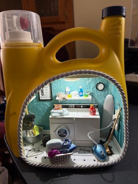 Yellow detergent bottle with a washer scene visible inside the label window