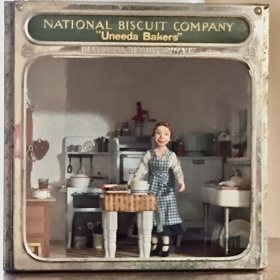 Vintage National Biscuit Company display with a doll in a checkered dress in a kitchen setting