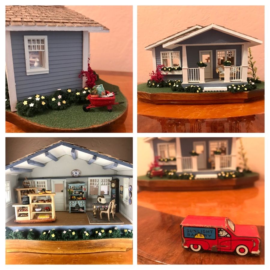 Miniature red truck and dollhouse scenes, including a gray house, porch, and shop interior display.