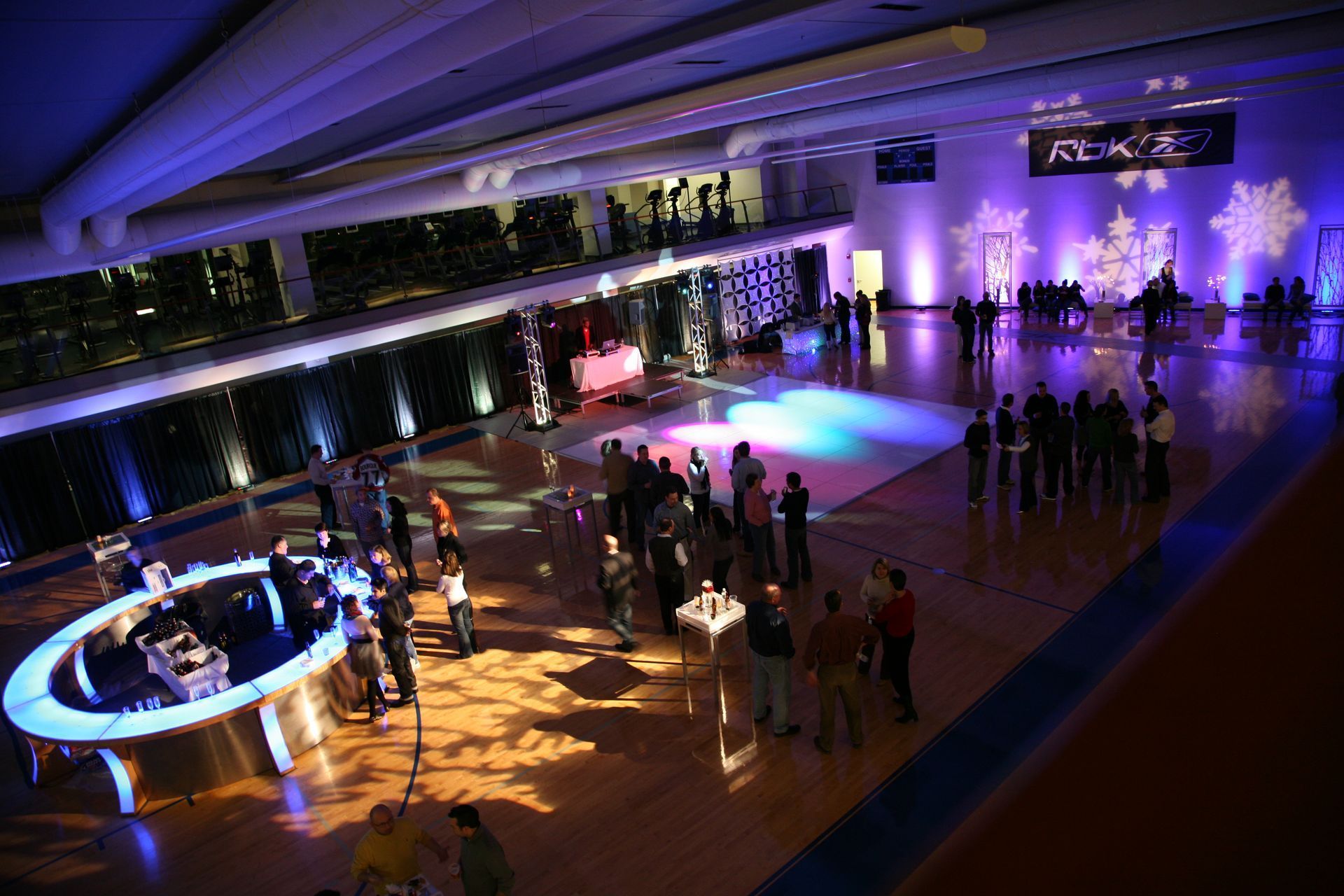 An aerial view of a large room with people dancing on a dance floor.