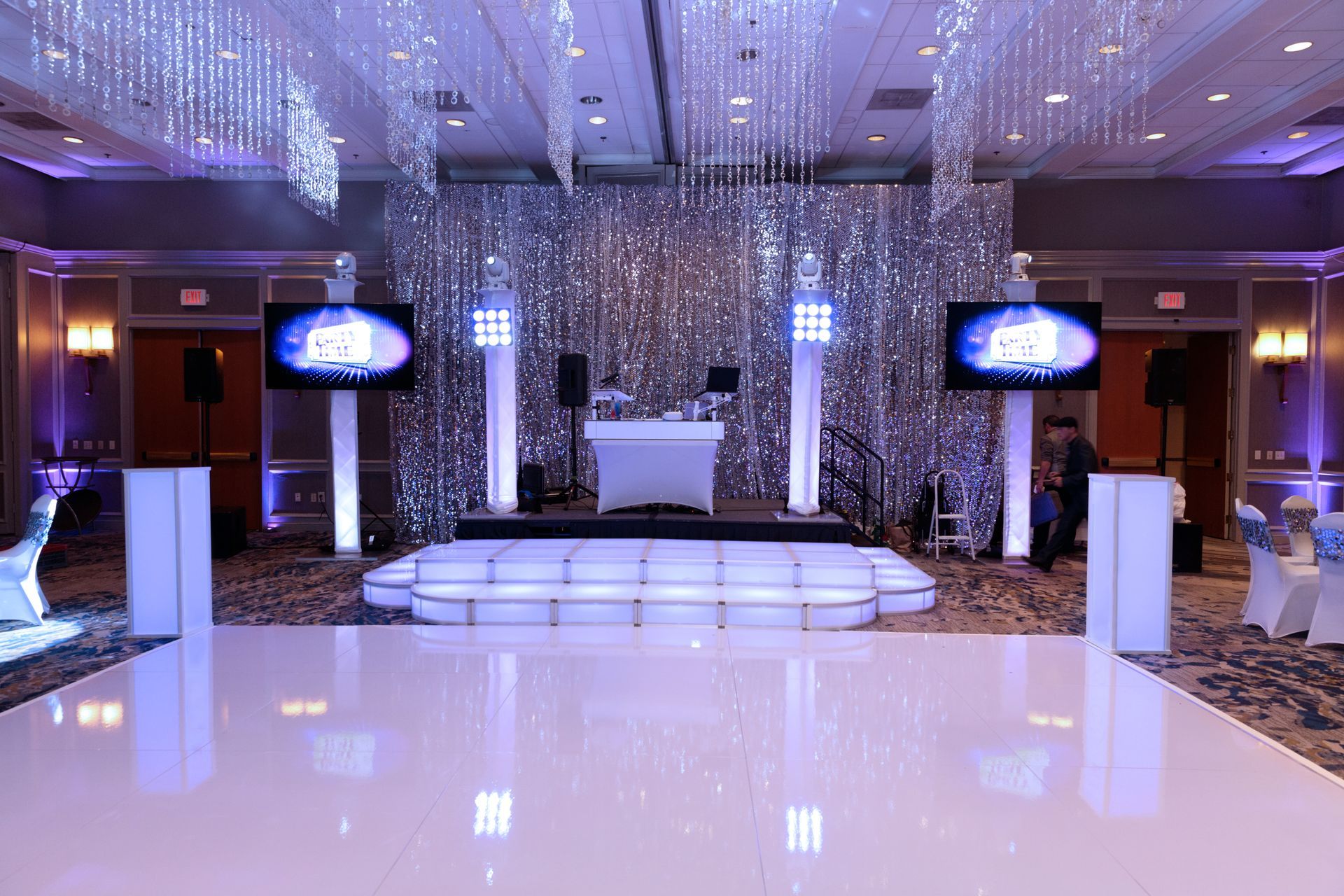 A large room with a dance floor and a dj set up