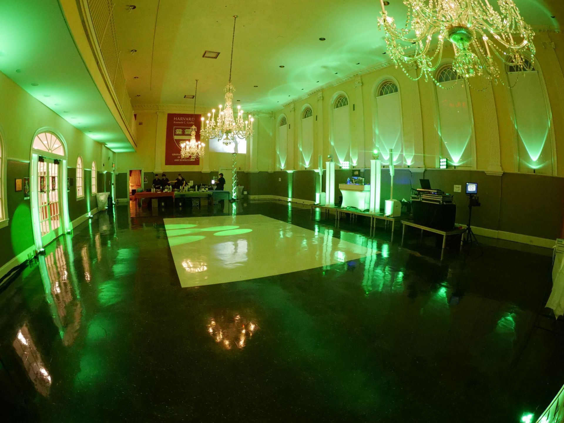 A large room with a dance floor and a chandelier.