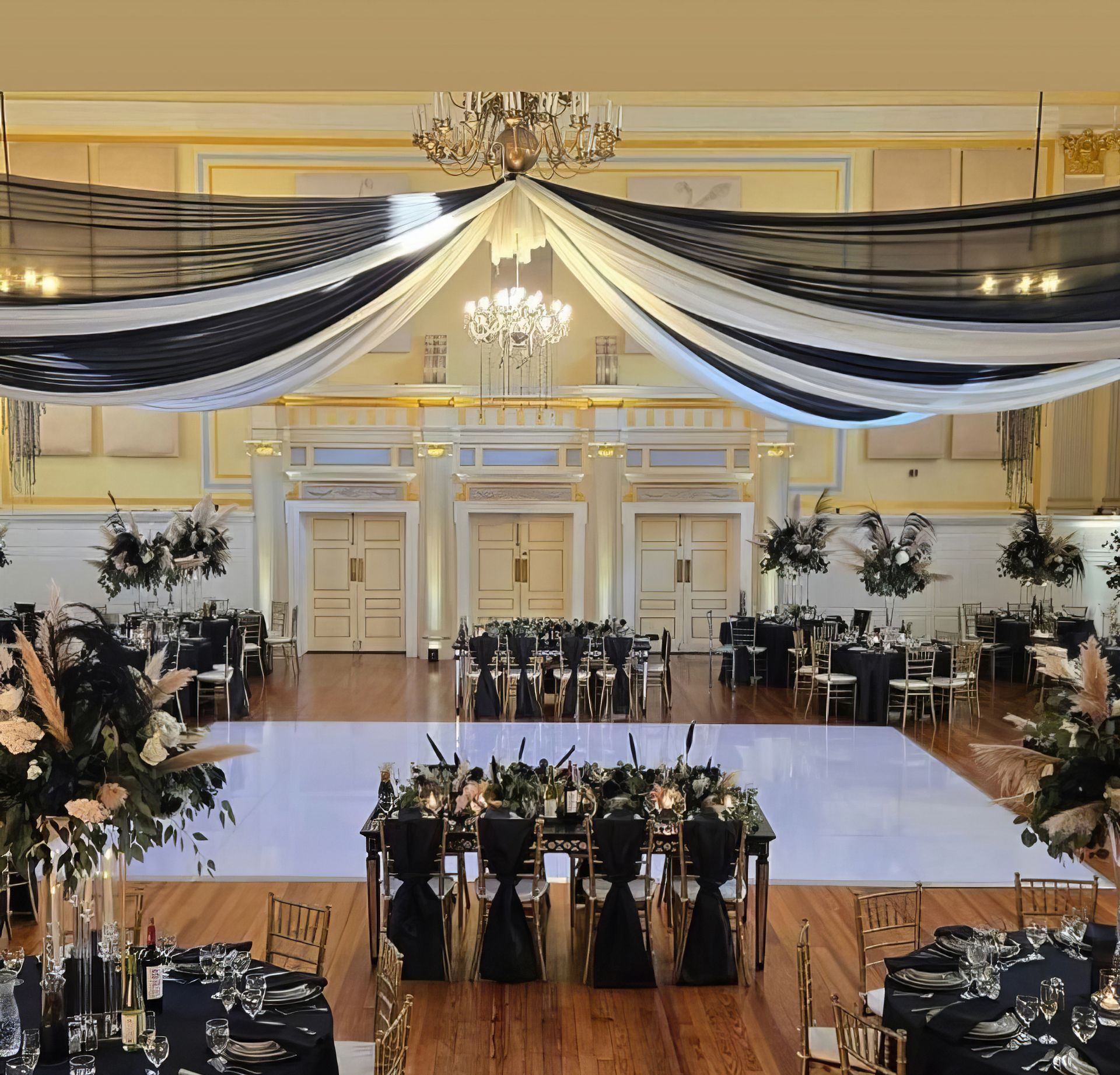 A bride and groom are dancing their first dance at a wedding reception.