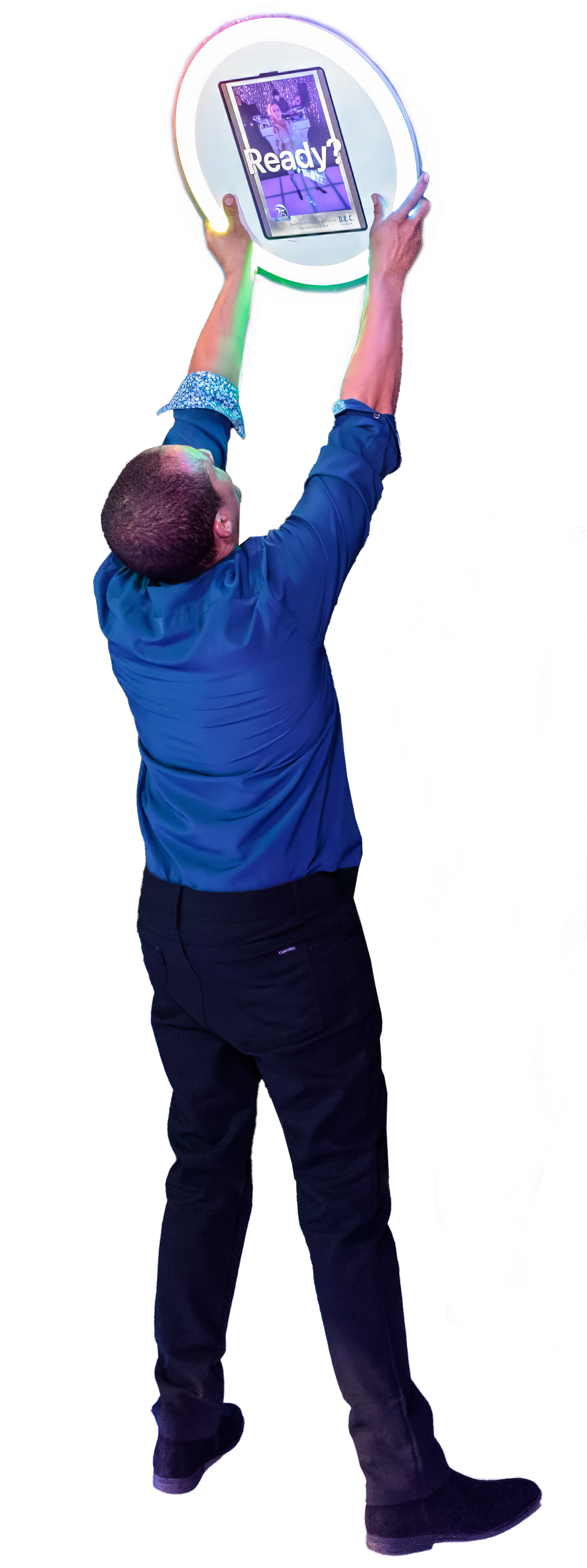 A man in a blue shirt is holding a soap bubble in his hands.