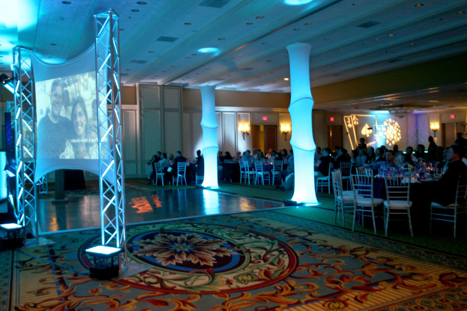 A large room with tables and chairs and a dance floor