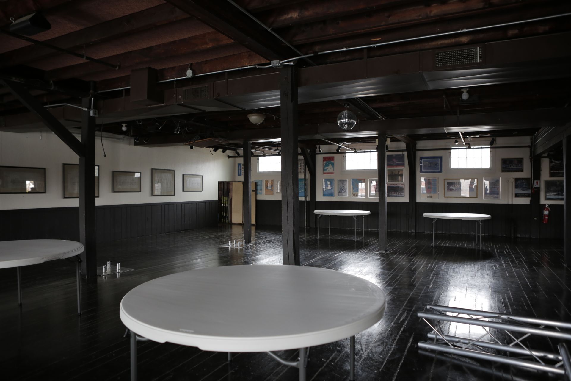 A large empty room with a round table in the middle
