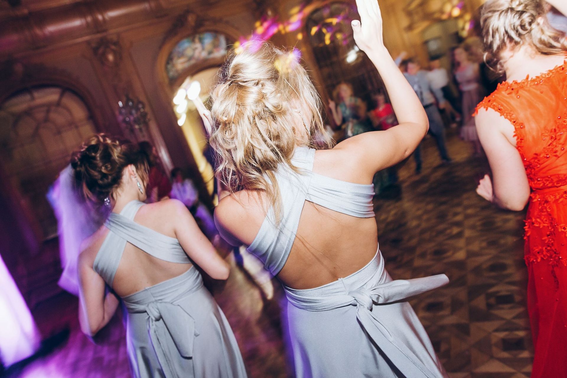 A group of women are dancing at a wedding reception.
