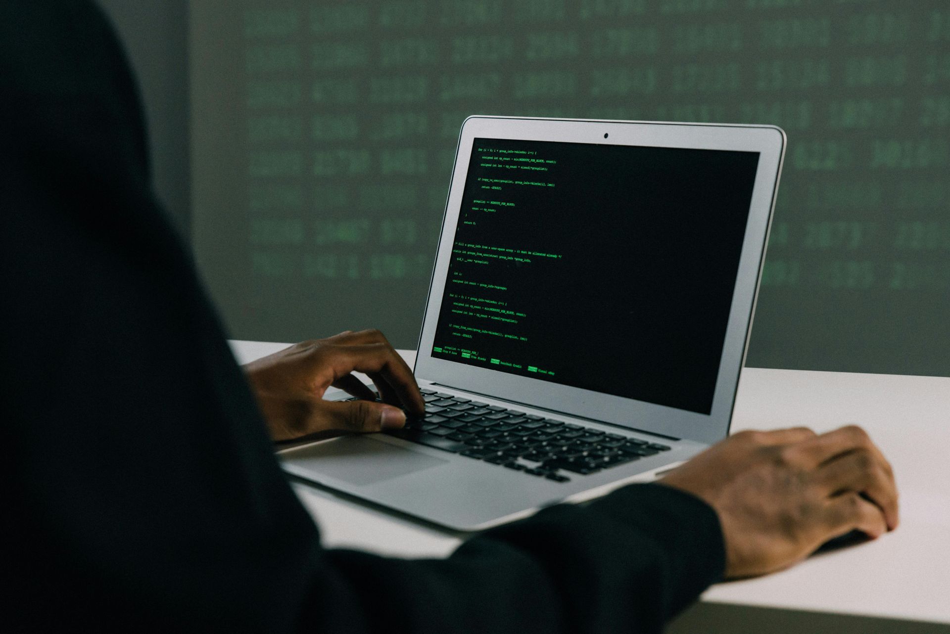 A person is typing on a laptop computer.