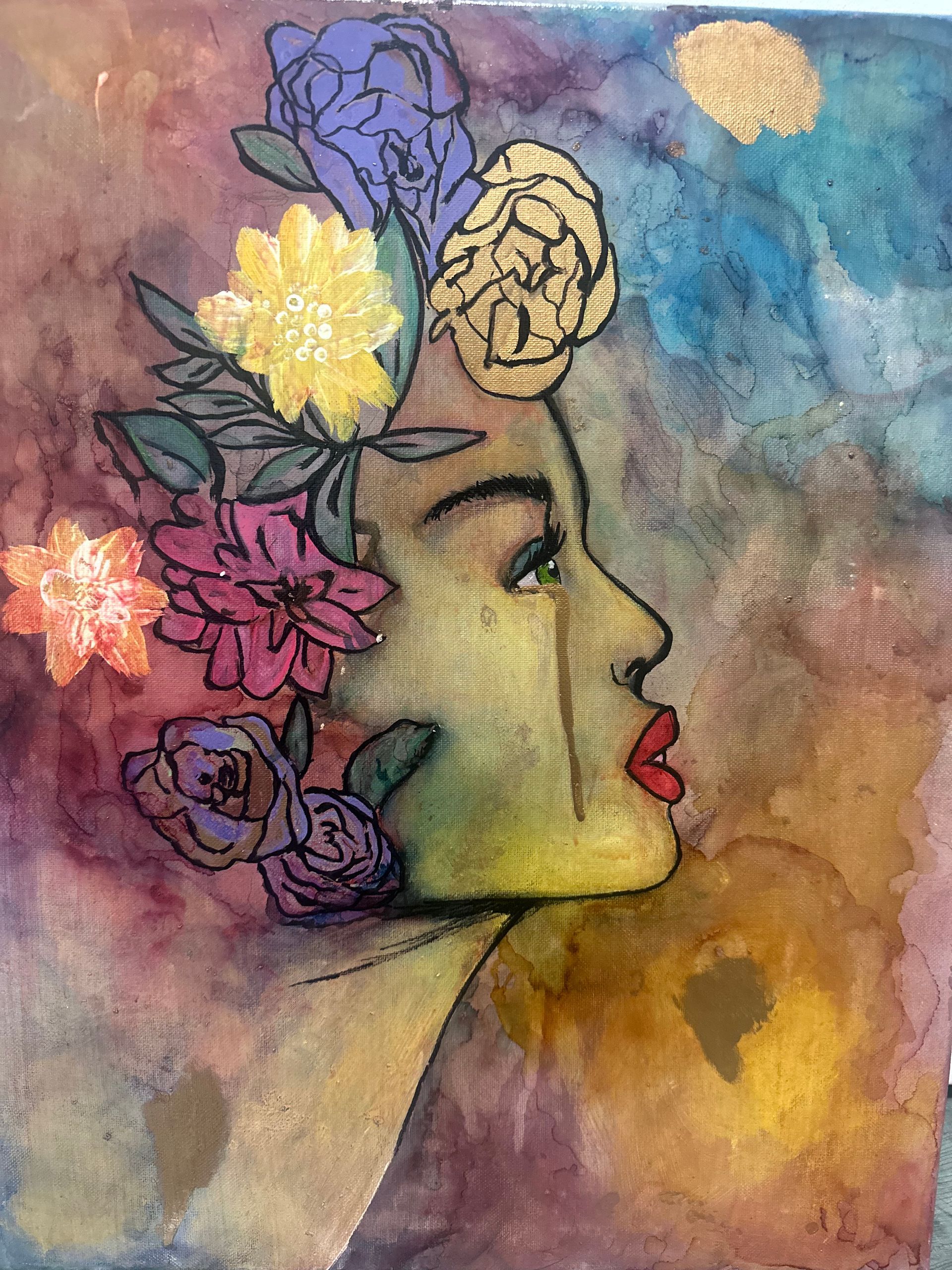 Profile of a face adorned with floral crown, streaks of color, and tears; colorful, artistic rendering.