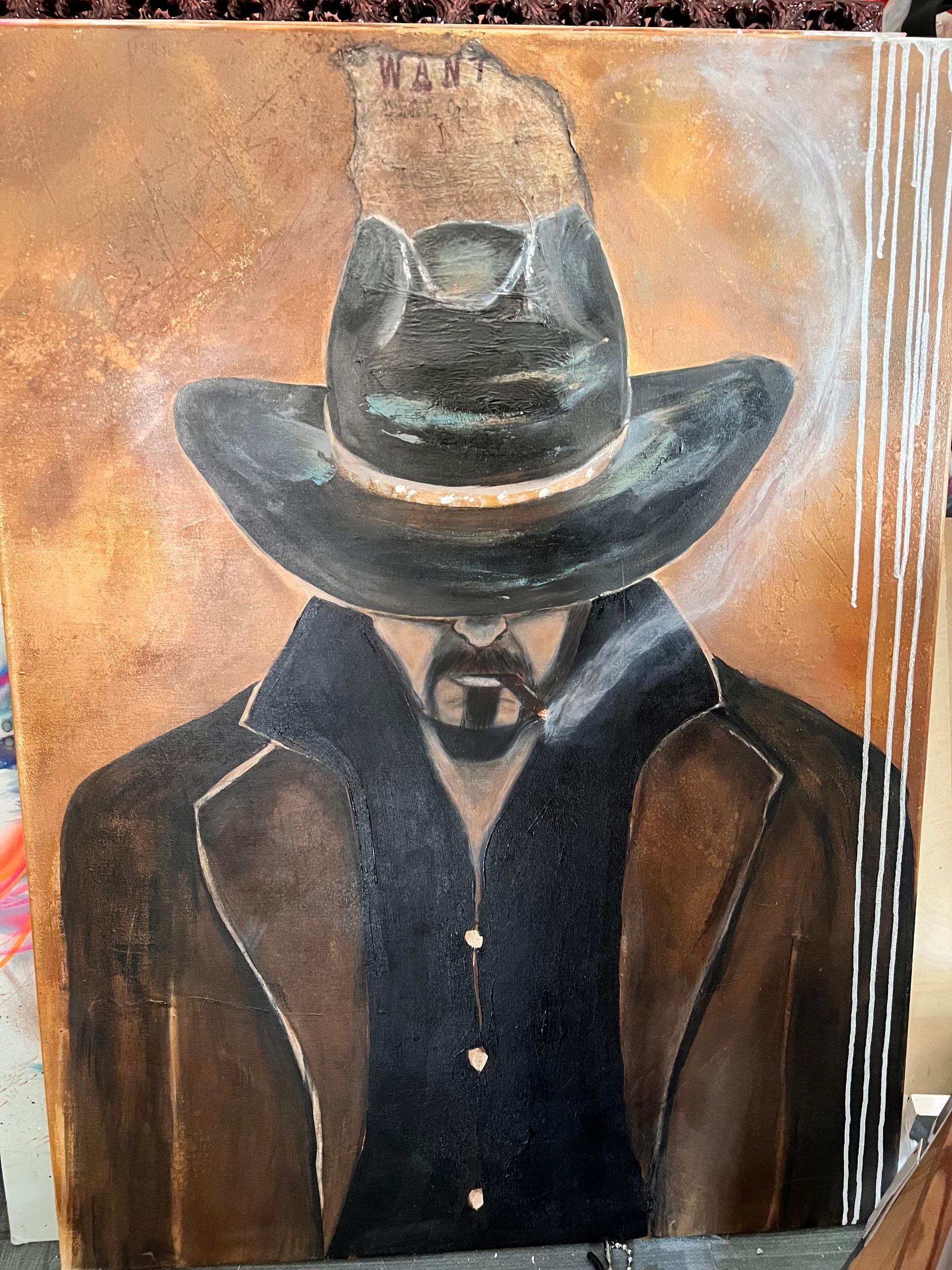 Cowboy with hat, dark coat, and cigar. Brown, black, and white colors.