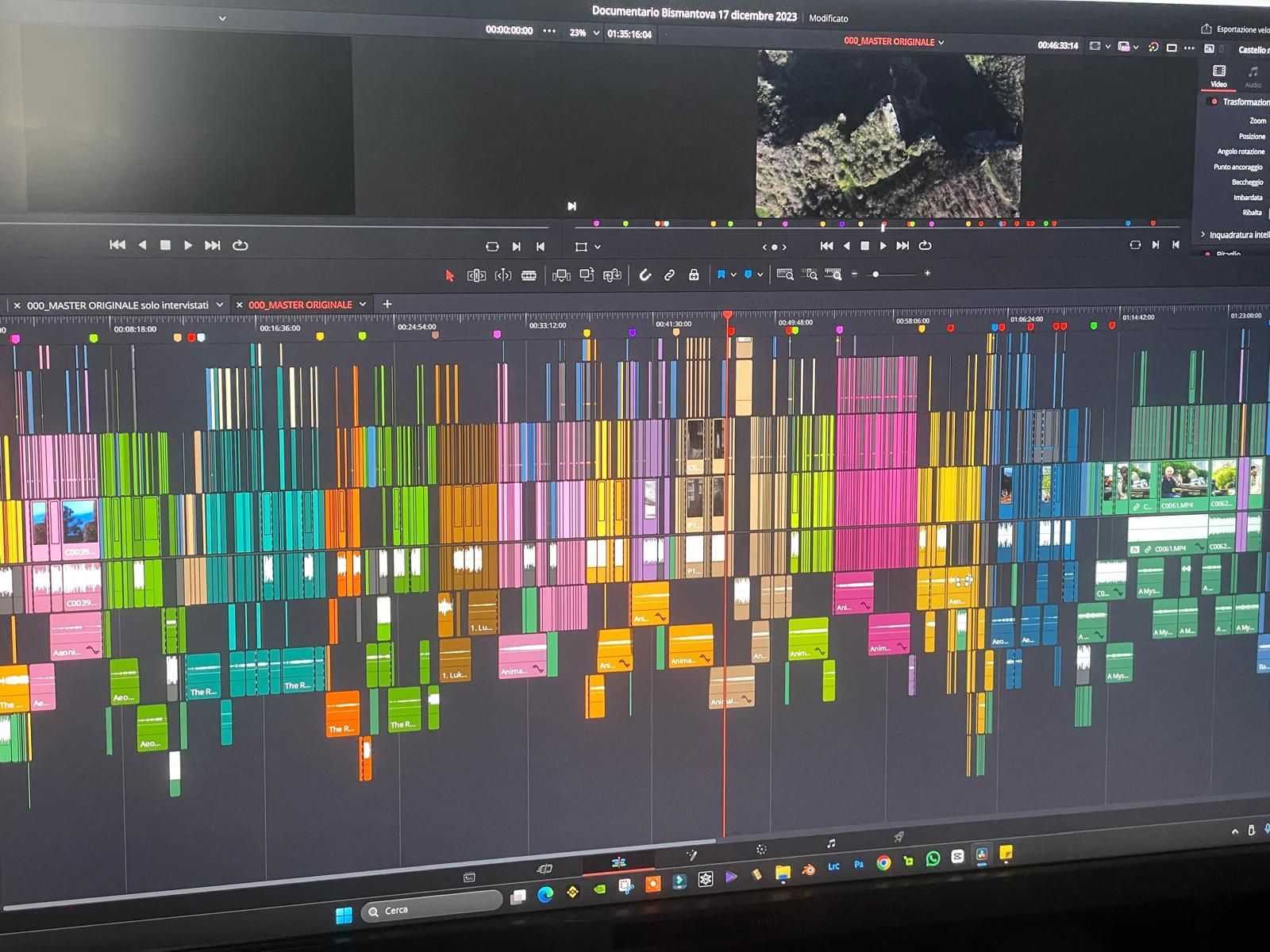 Video editing software timeline, colorful segmented video clips displayed on-screen.