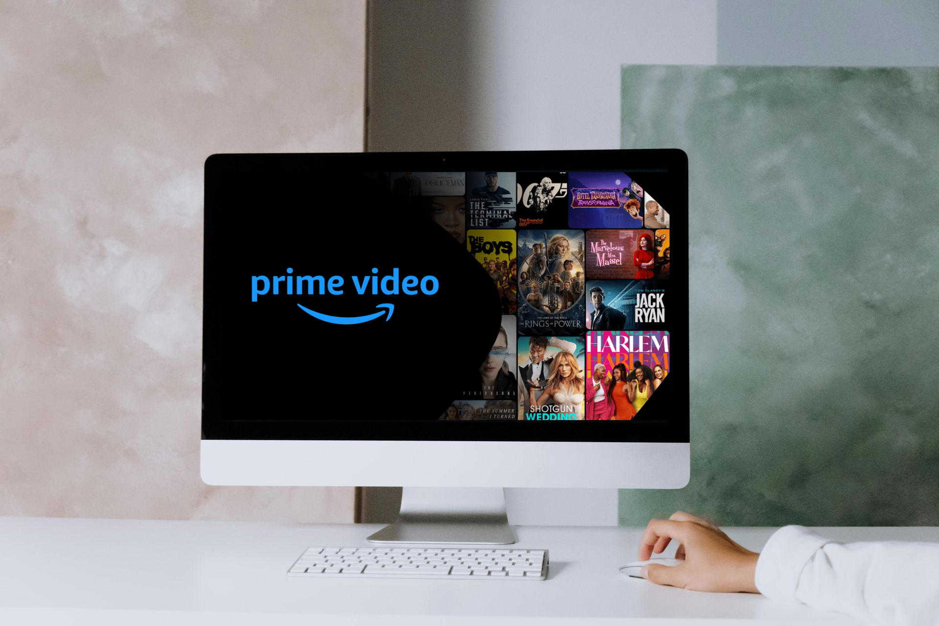 A person using a computer to browse a streaming service. The screen displays movie/show thumbnails.