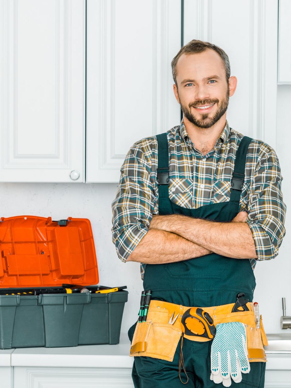 plumber smiling at camera with arms crossed