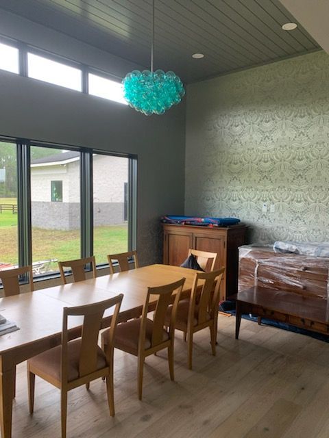 A dining room with a long table and chairs