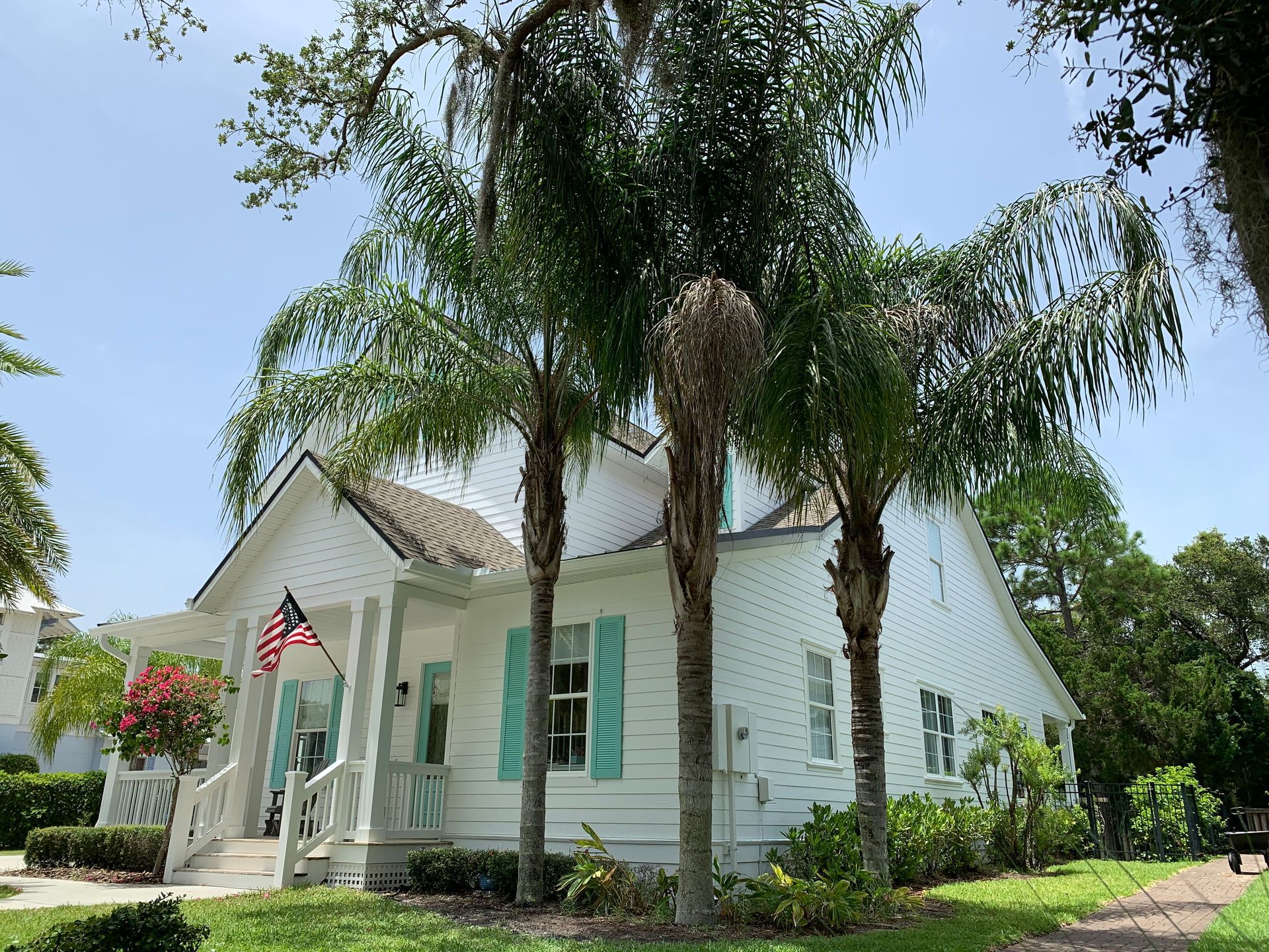 A white house with palm trees in front of it