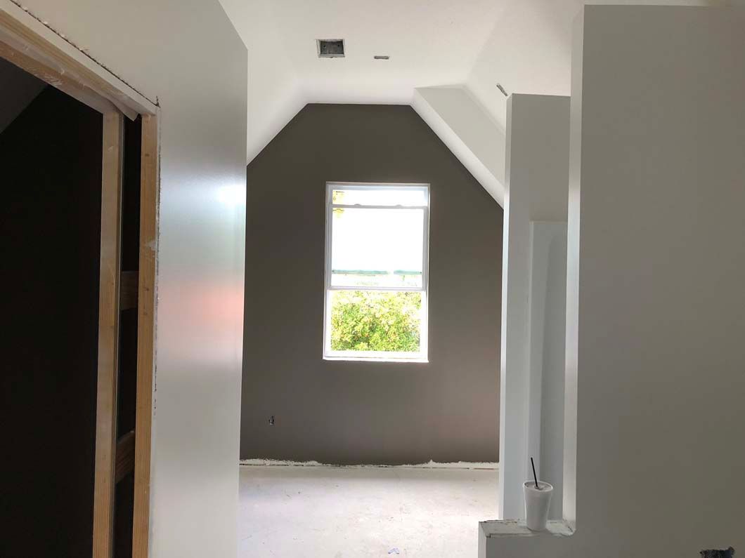 There is a window in the corner of the room.