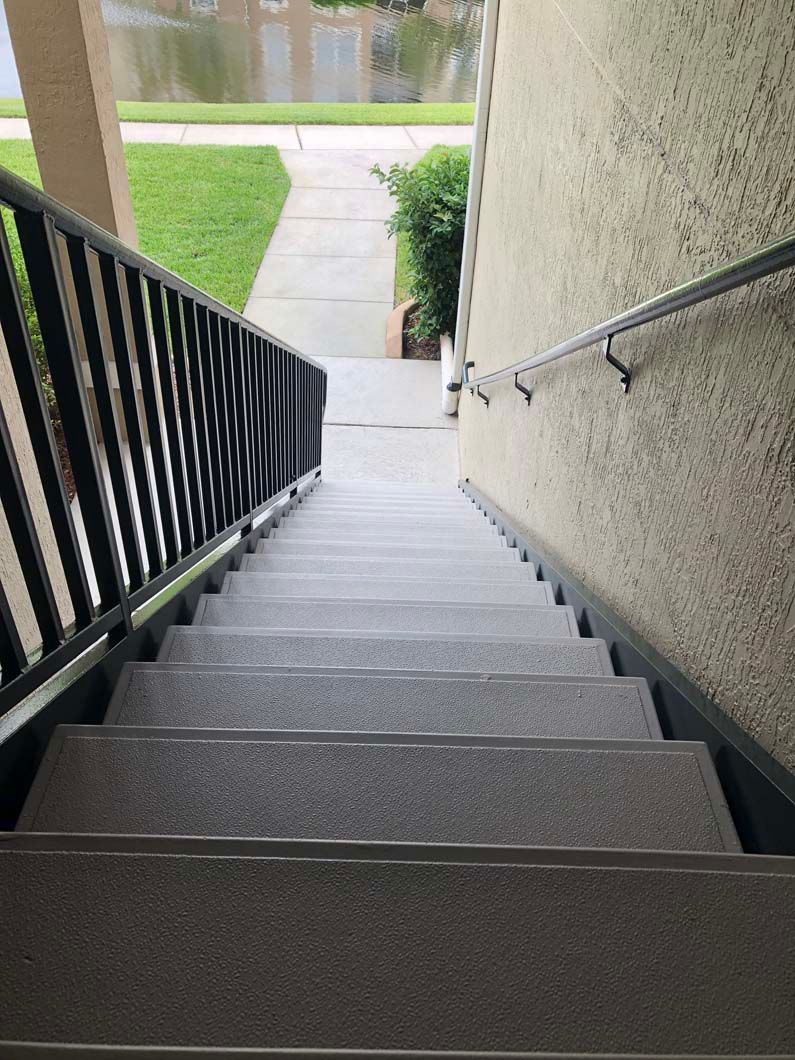 A set of stairs leading up to a building with a railing.