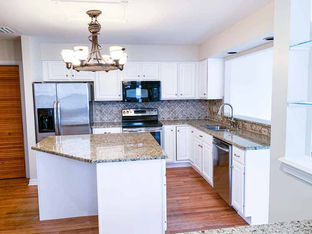 A kitchen with stainless steel appliances and granite counter tops