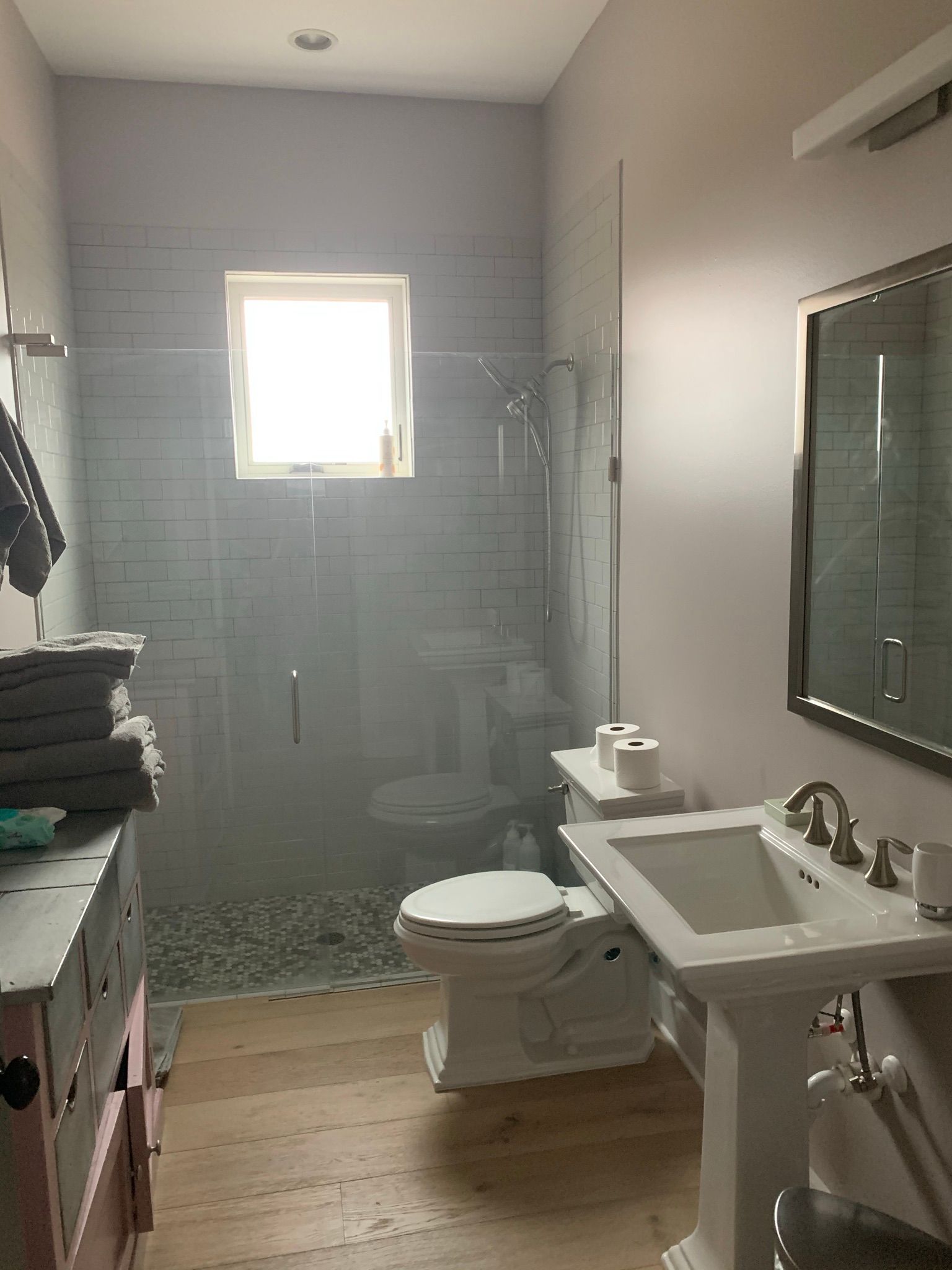A bathroom with a toilet , sink , and shower.