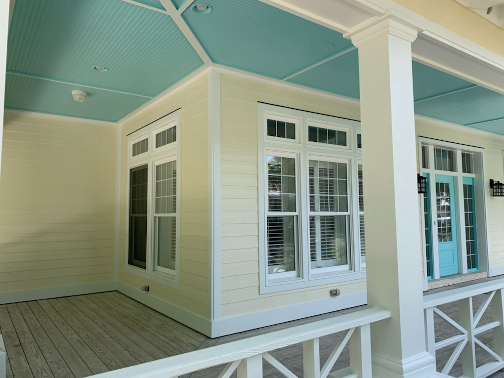 A house with a porch and a blue ceiling