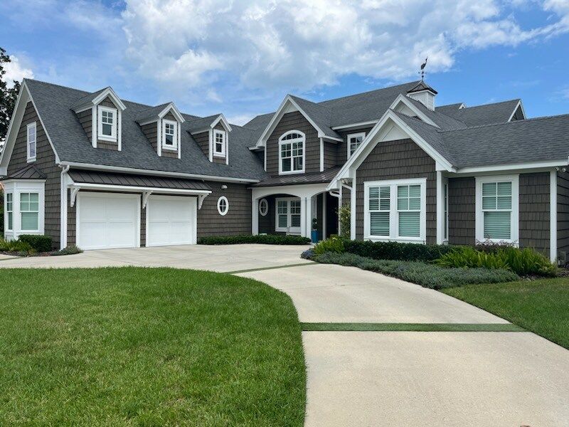 A large house with two garages and a driveway