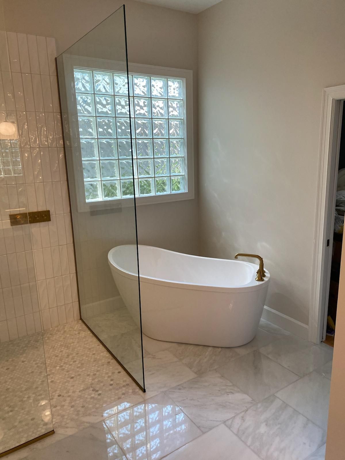 A bathroom with a bathtub and a walk in shower.