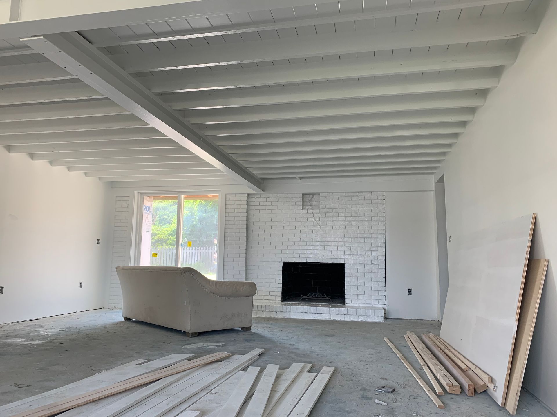 An empty living room with a fireplace and a couch