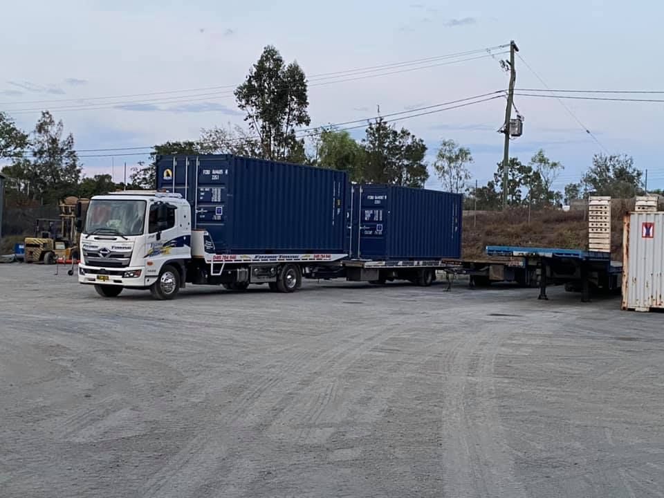 A Truck With Two Blue Cargo Containers — Fitzroy Towing & Transport in Parkhurst, QLD